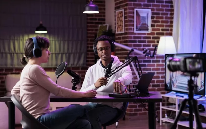 Man and woman recording podcast talk show on camera